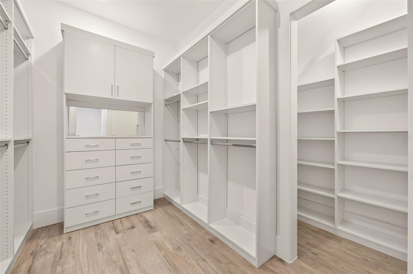 Primary bedroom walk-in closet