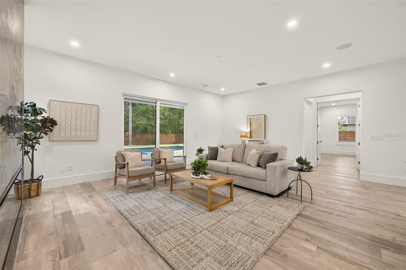 Living room with sliding glass doors to the covered lanai & pool