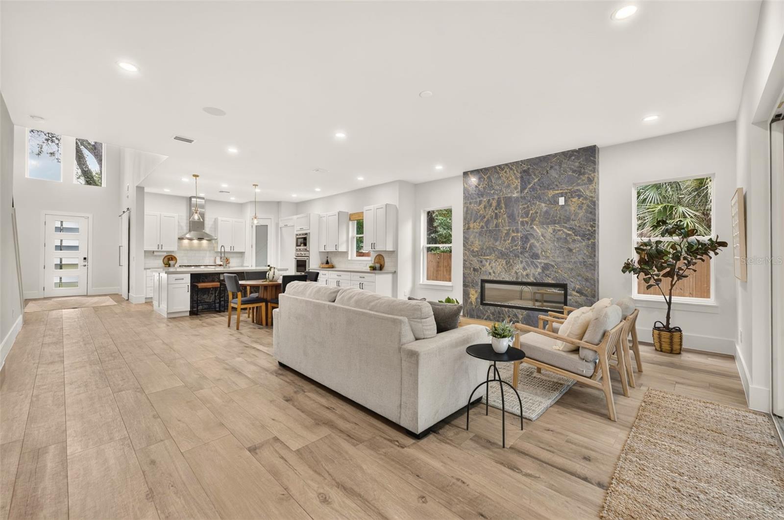 Washed oak porcelain plank tile flooring throughout the 1st floor