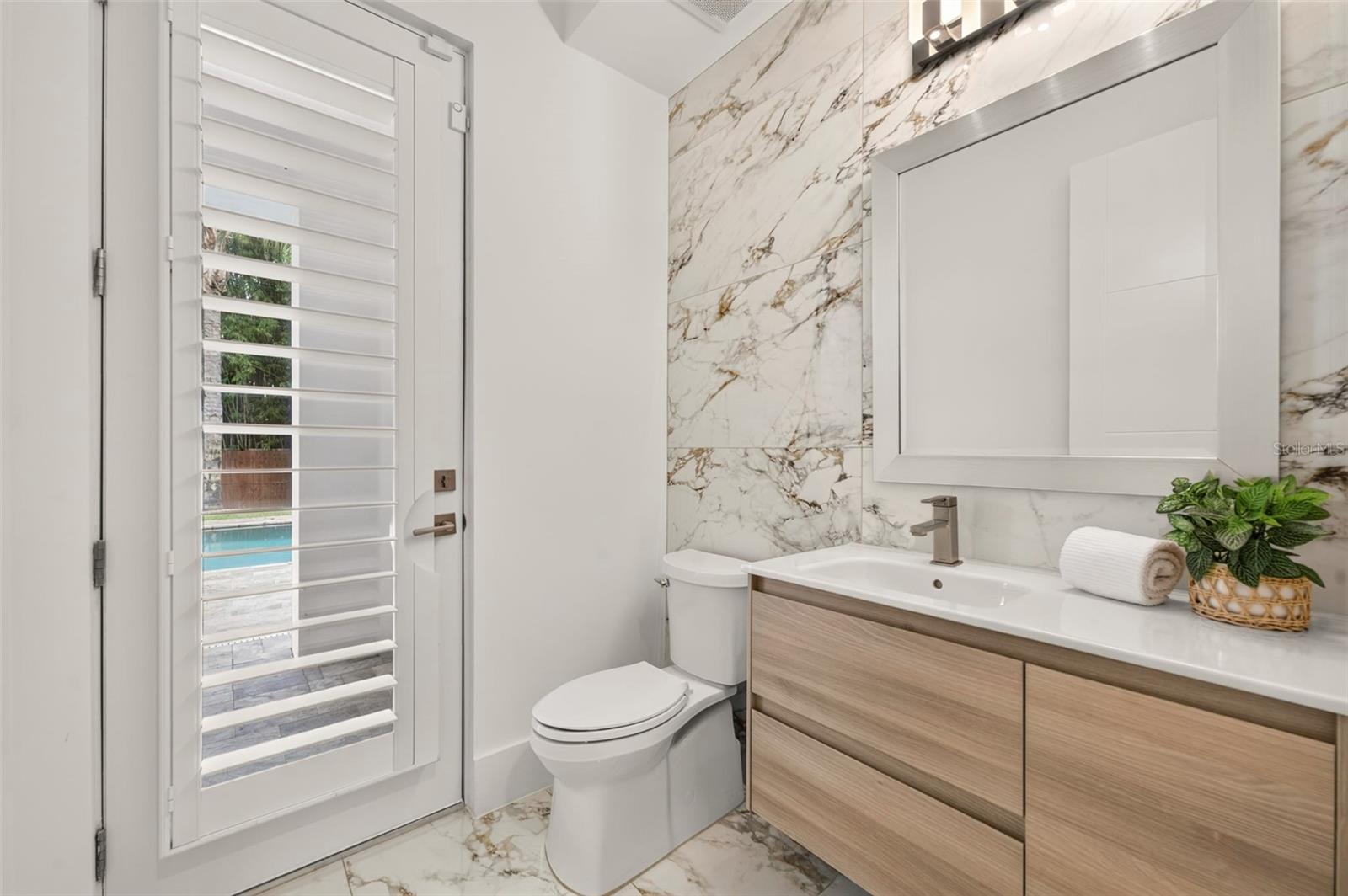 Renovated pool/powder bath with gorgeous floor-to-ceiling tile
