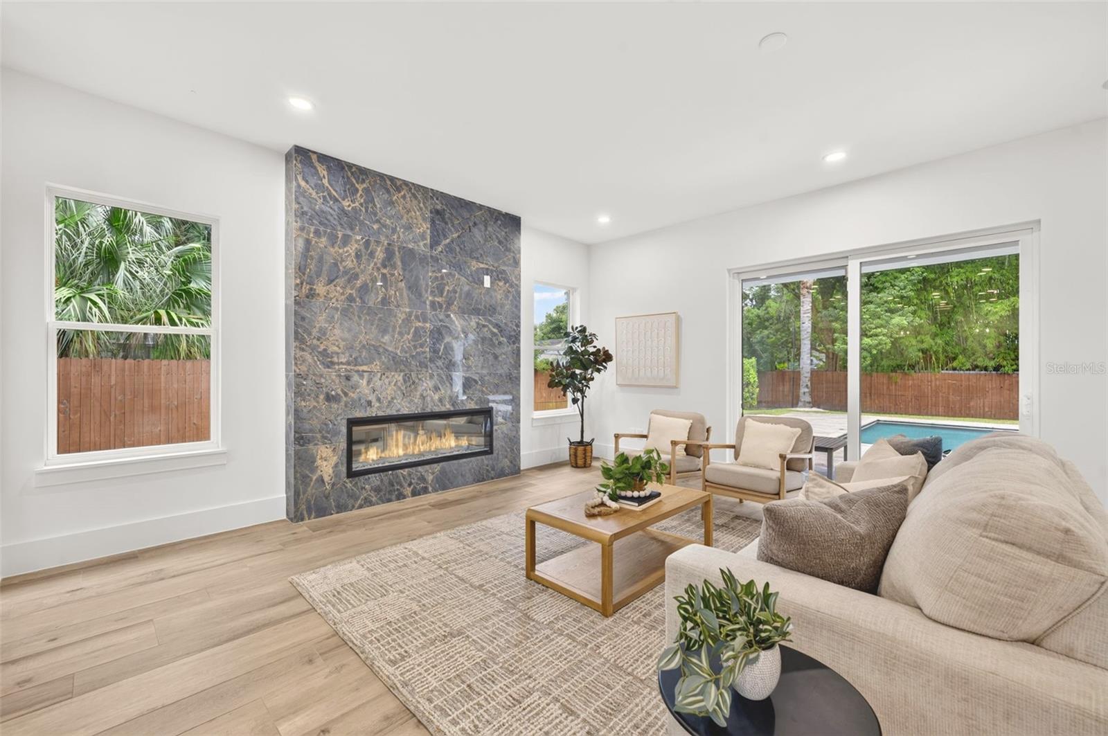 Living room with custom-built fireplace & stylish tile surround