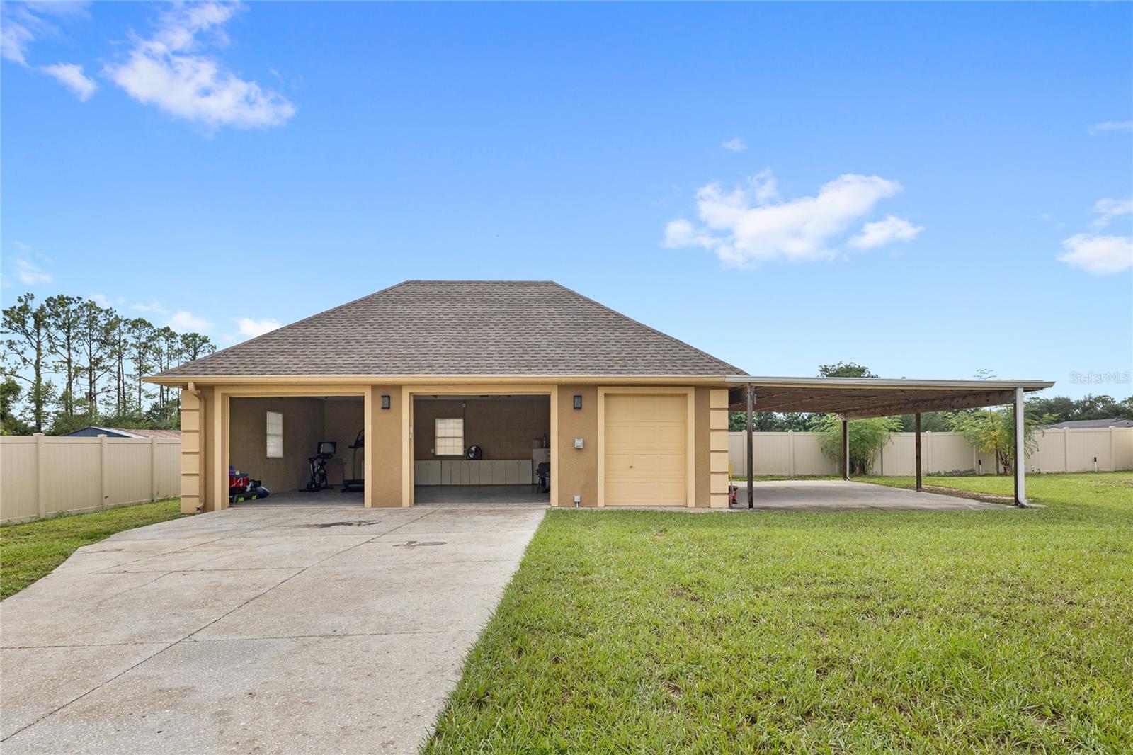Detached two car garage with storage room and carport