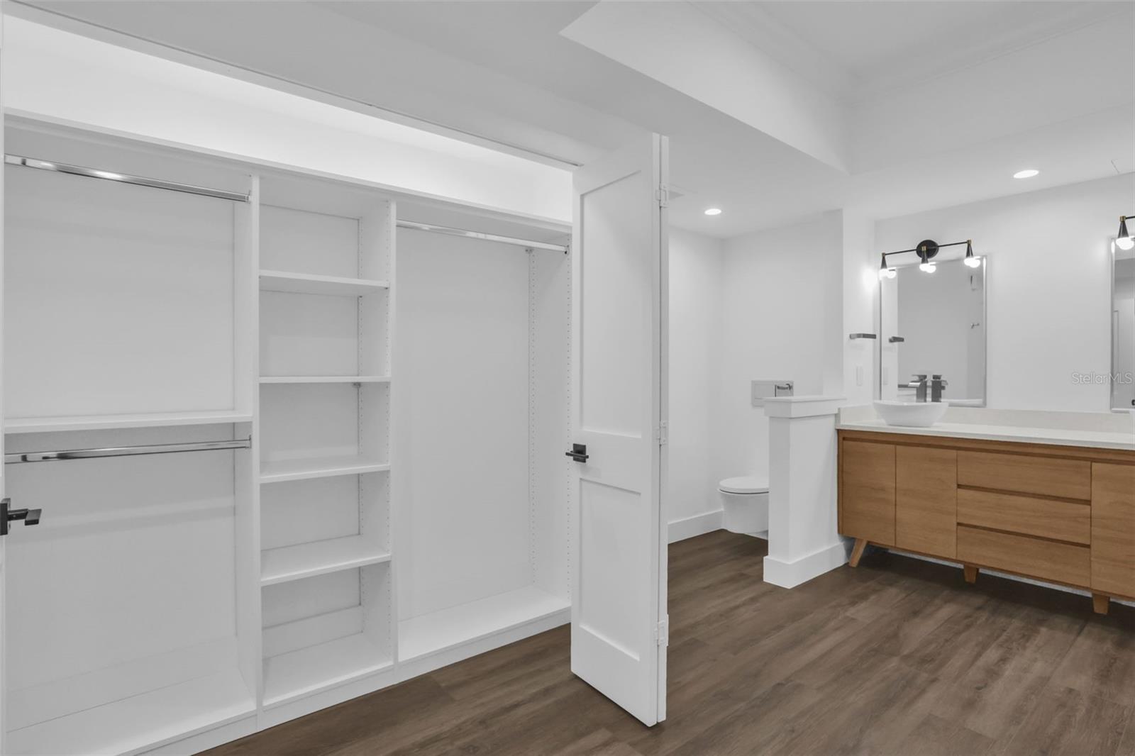 Primary Bath with Two Custom Closets with Built-ins