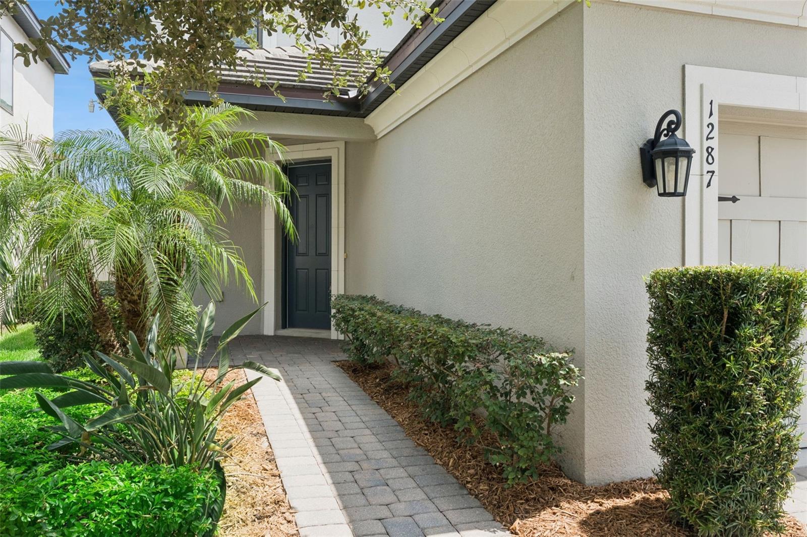 Front Entry  A landscaped paver walkway leads to the covered front entry, creating an inviting approach to the home.