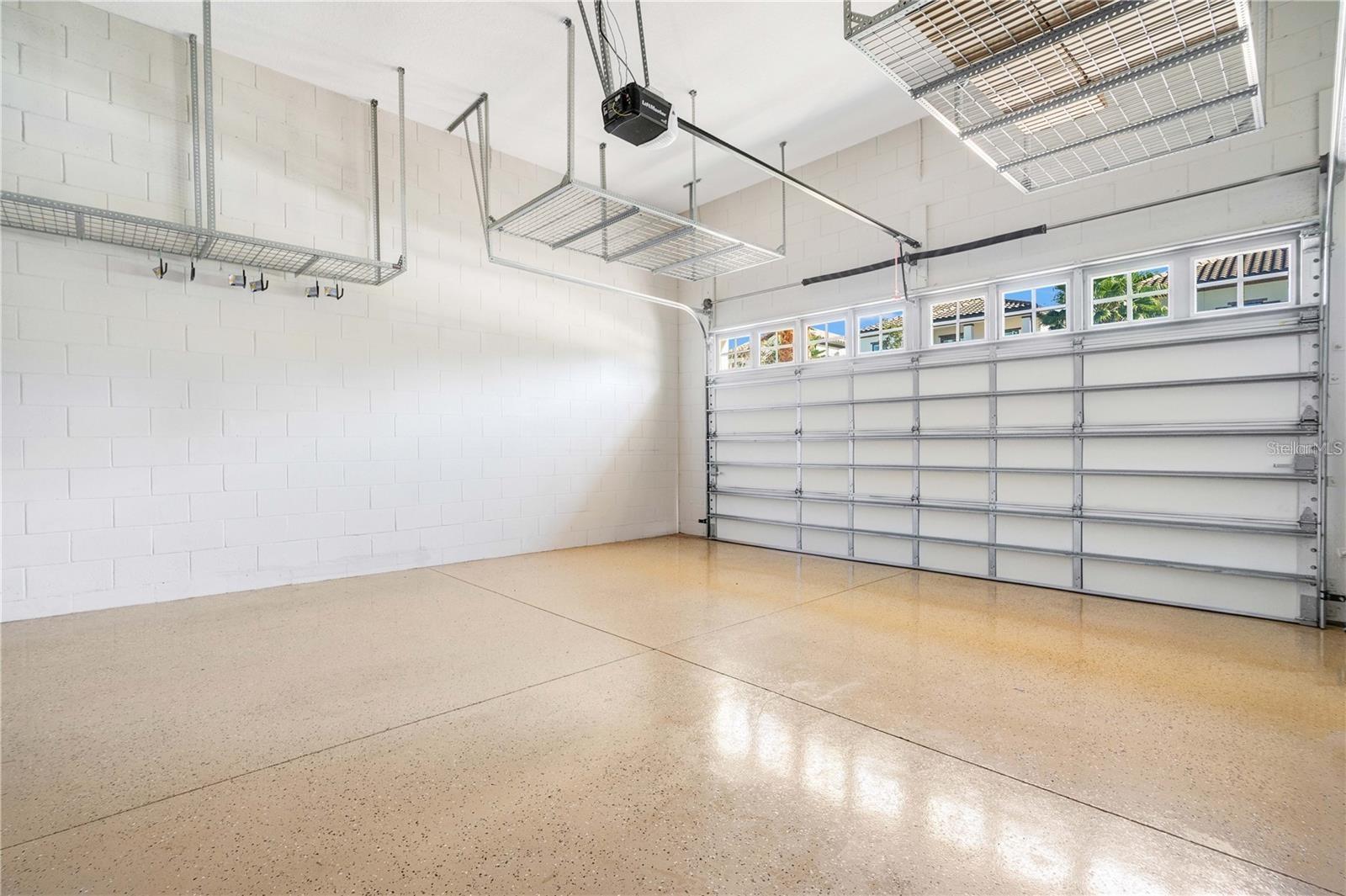 Garage has high ceilings & ample storage