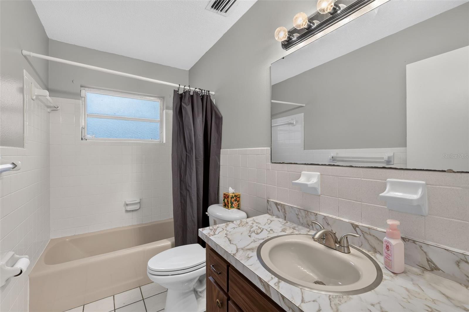 Full Guest Bathroom Conveniently Located Next to the Second Bedroom