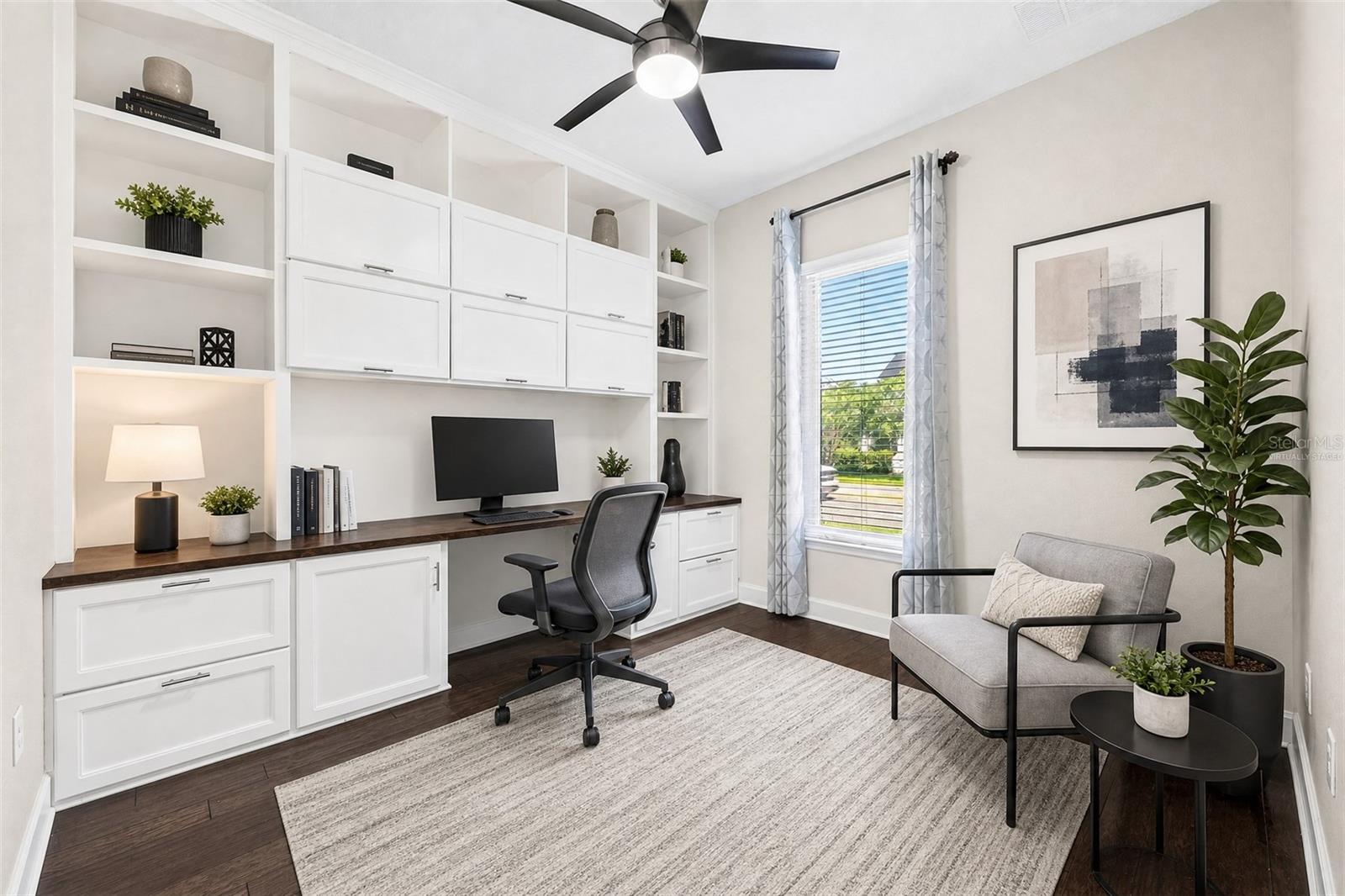 Office/flex space at the front of the home features custom built-ins. Virtually Staged.