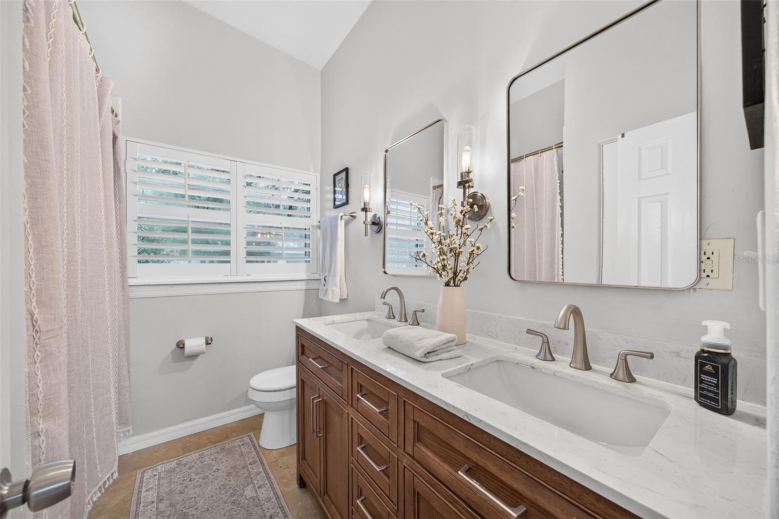 Renovated full hall bath with double sink vanity