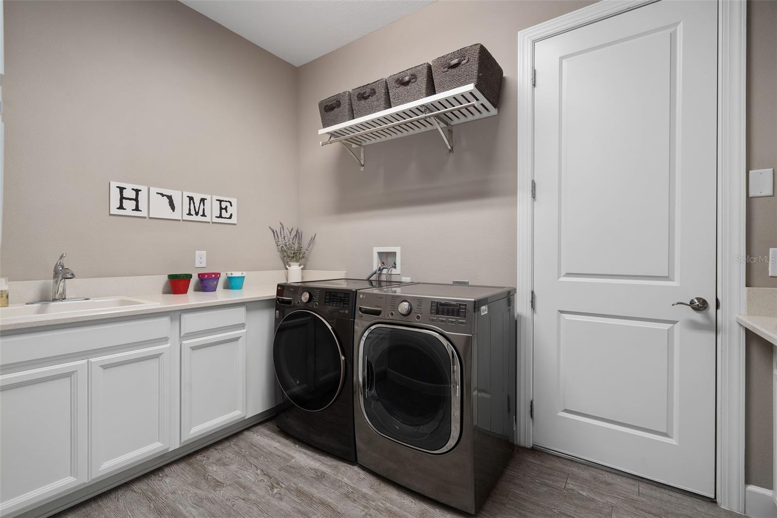 The laundry room has a sink and a drop area for your convenience.
