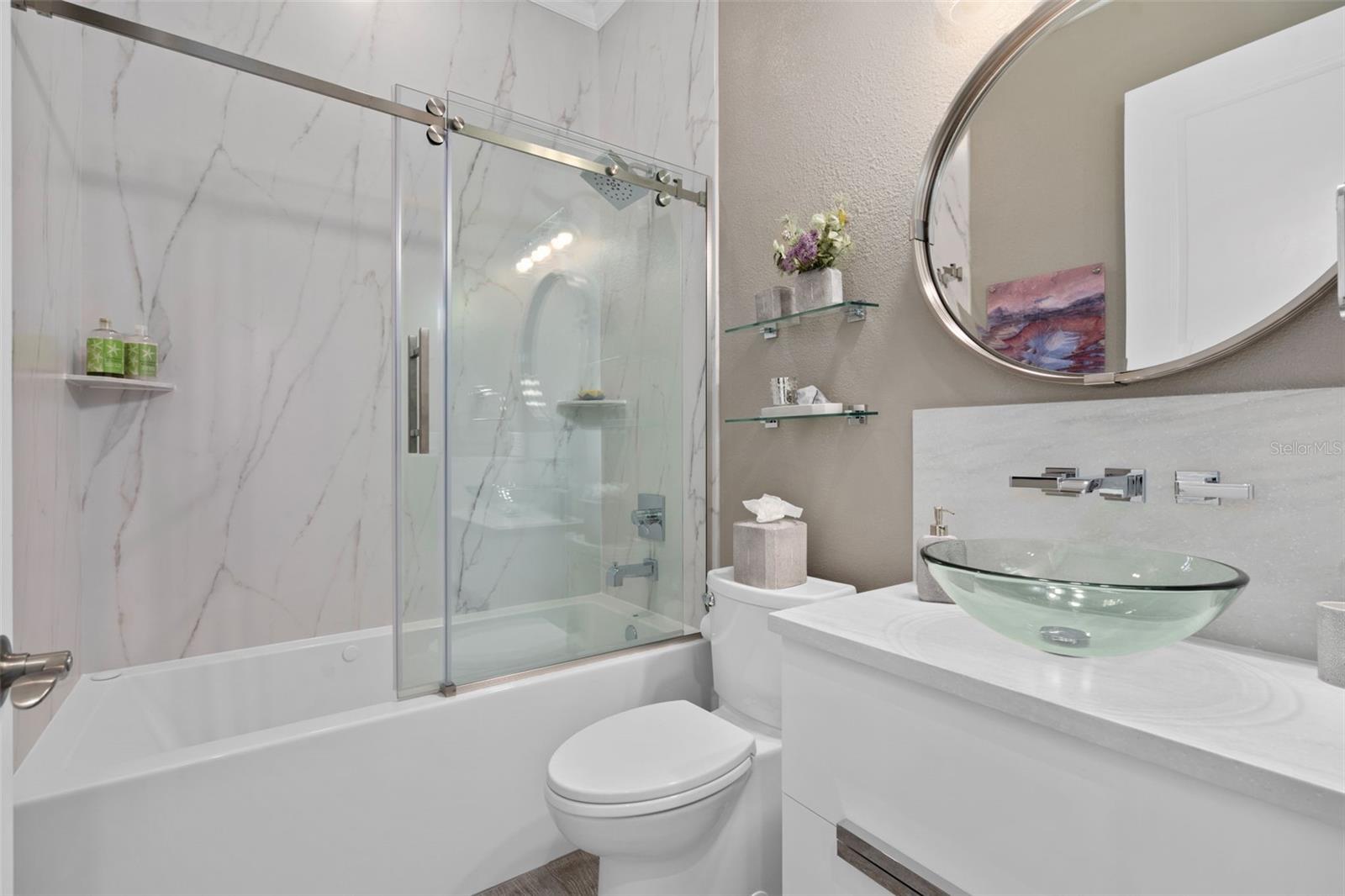 The Remodeled bathroom 3 is adjacent to Bedroom 3. The jetted tub also has bubblers in the base and is longer than a typical tub for your comfort. A stunning vanity, vessel sink and accessories adds the finishing touches.