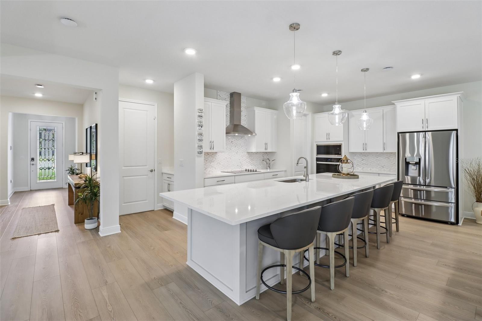 The OPEN-CONCEPT MAIN FLOOR centers around a must-see CHEF'S KITCHEN featuring sleek countertops, extensive cabinetry and storage, a decorative backsplash, pendant lighting, built-in STAINLESS STEEL APPLIANCES and a HUGE ISLAND with bar seating. The OPEN-CONCEPT MAIN FLOOR centers around a must-see CHEF'S KITCHEN featuring sleek countertops, extensive cabinetry and storage, a decorative backsplash, pendant lighting, built-in STAINLESS STEEL APPLIANCES and a HUGE ISLAND with bar seating.