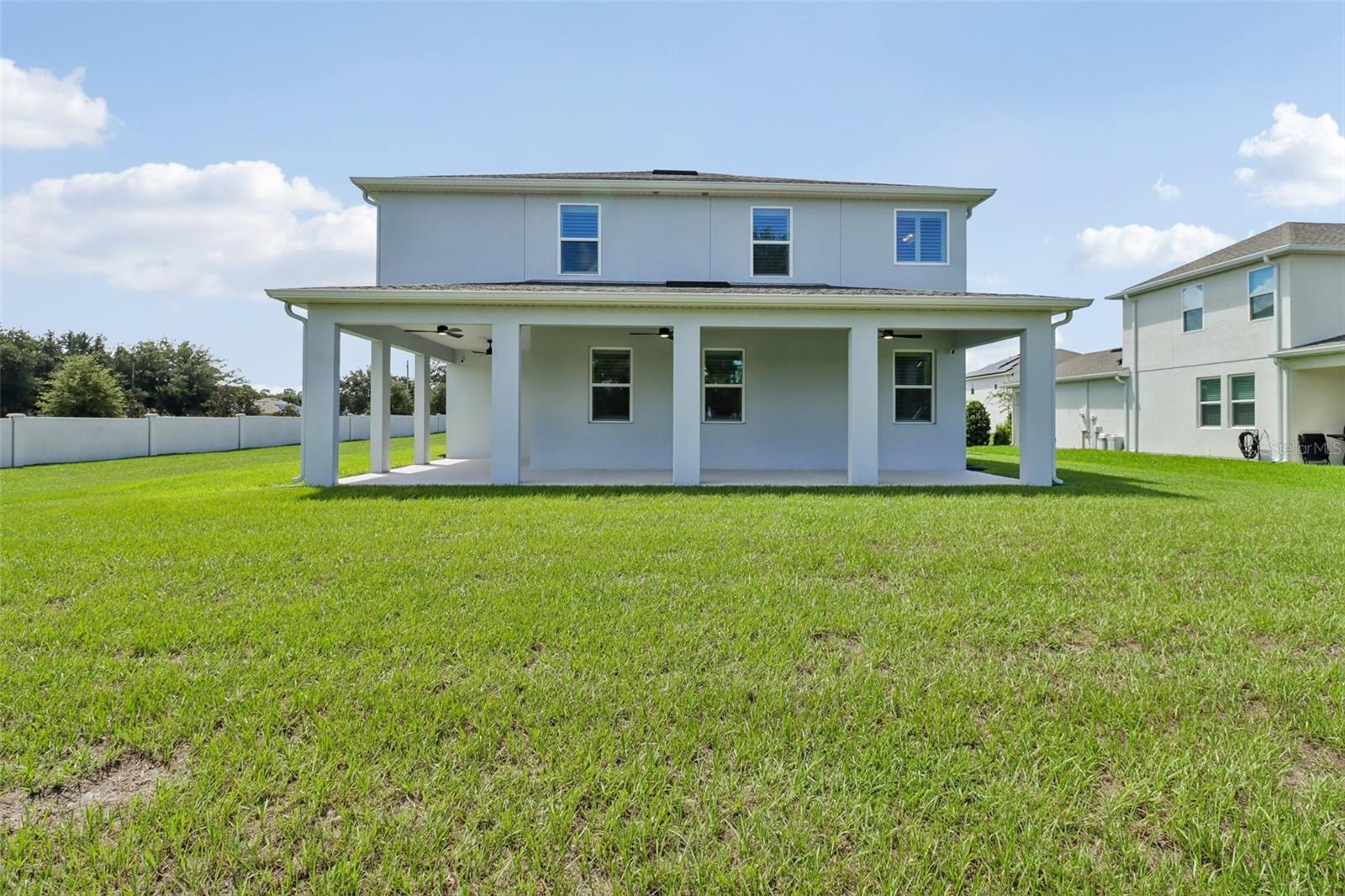 Wrap around lanai overlooks a large yard.