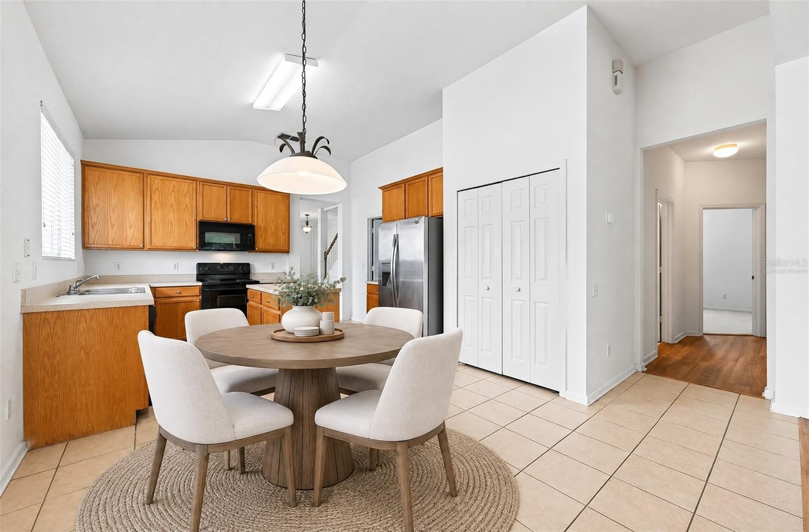 Casual dining off the kitchen, open to the family room. Virtually Staged.