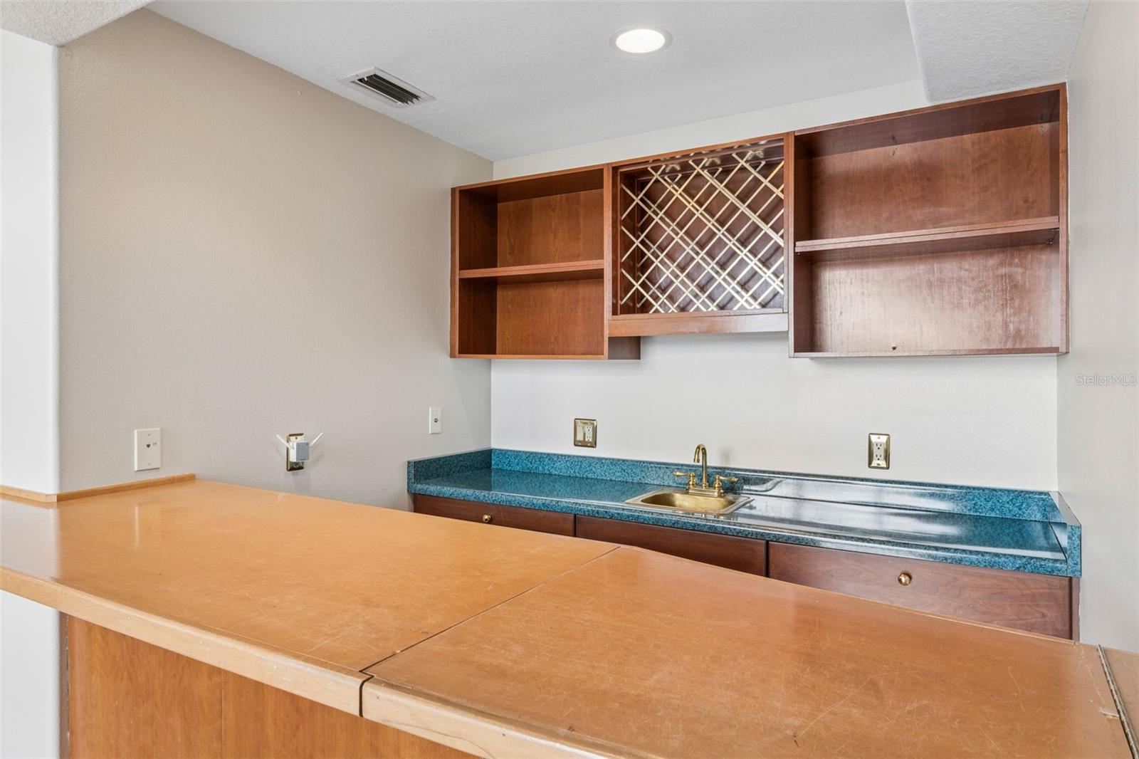 Built-in wet bar connected to the sunken great room, perfect for entertaining.