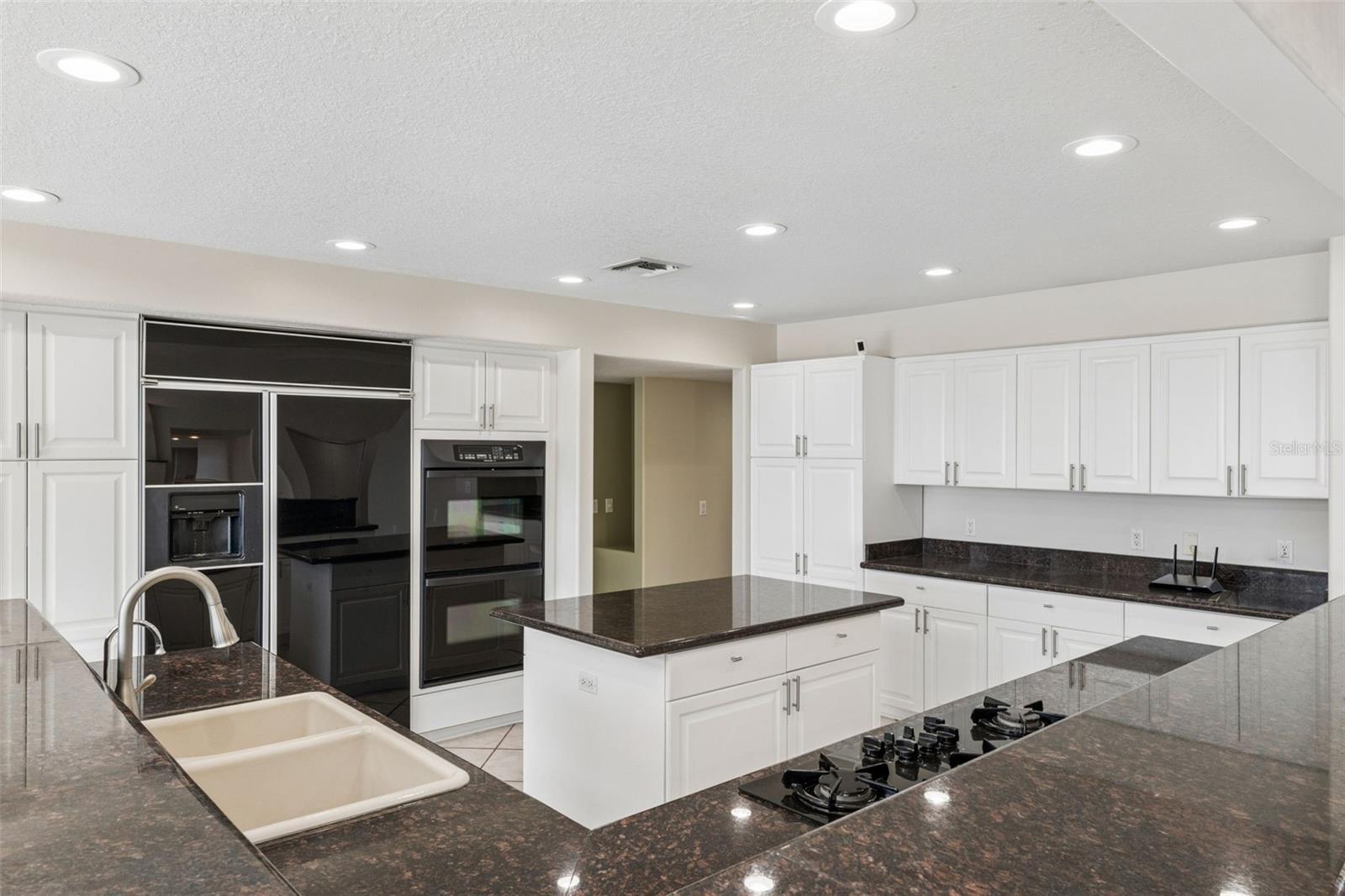 Spacious kitchen with abundant cabinetry, center island, and generous prep space for everyday living and entertaining.