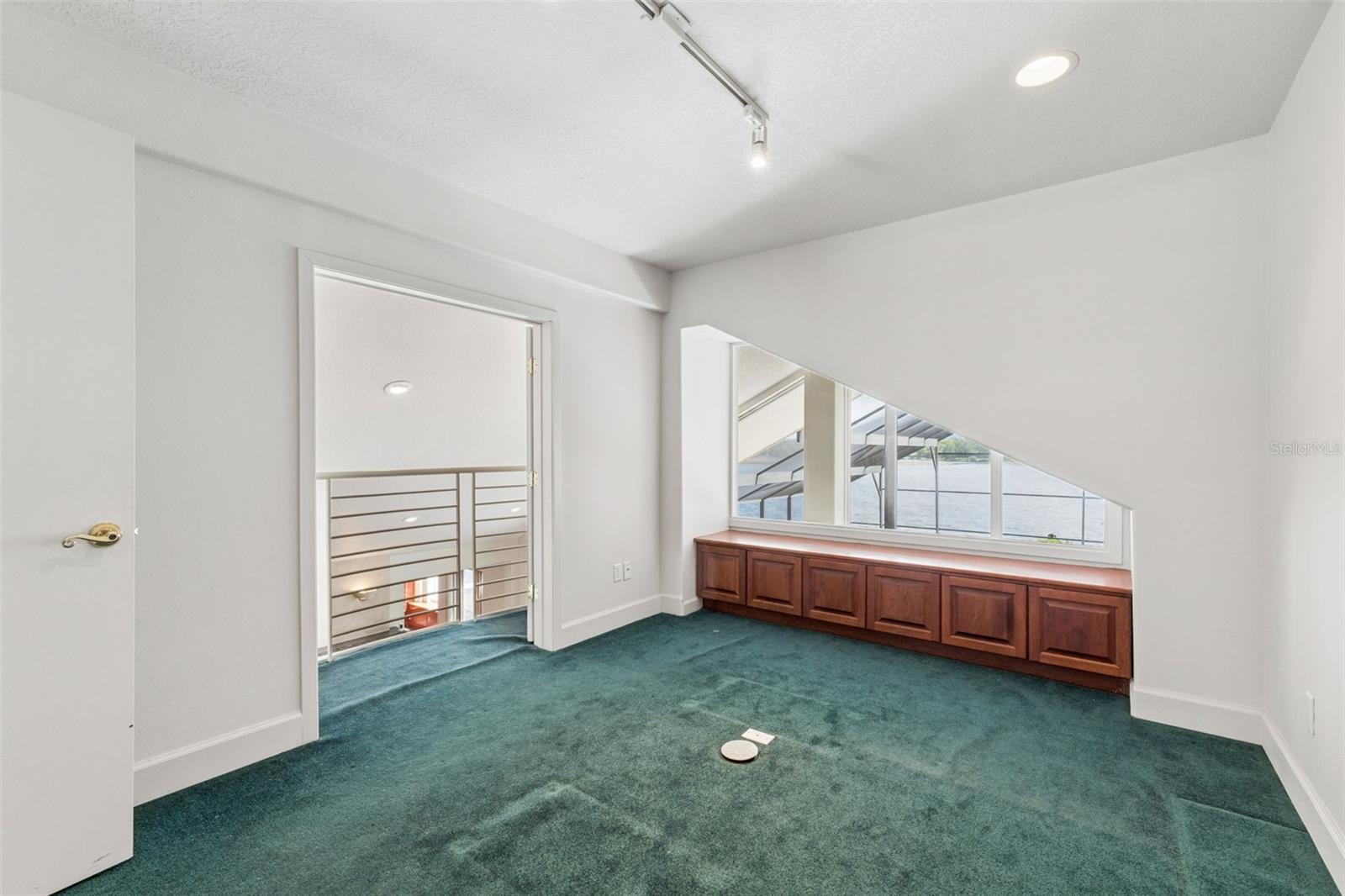 Loft office with lake views and a balcony overlook to the living room below.