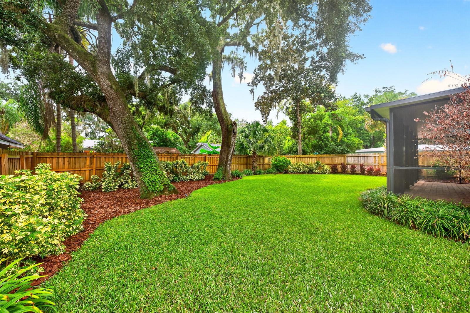 The park-like setting of the private backyard creates a tranquil retreat.