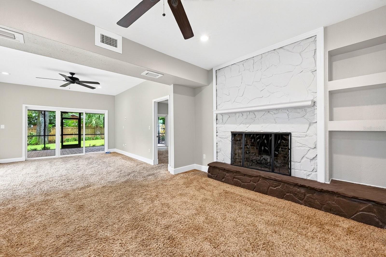 The first area of the family room features a fireplace feature wall.