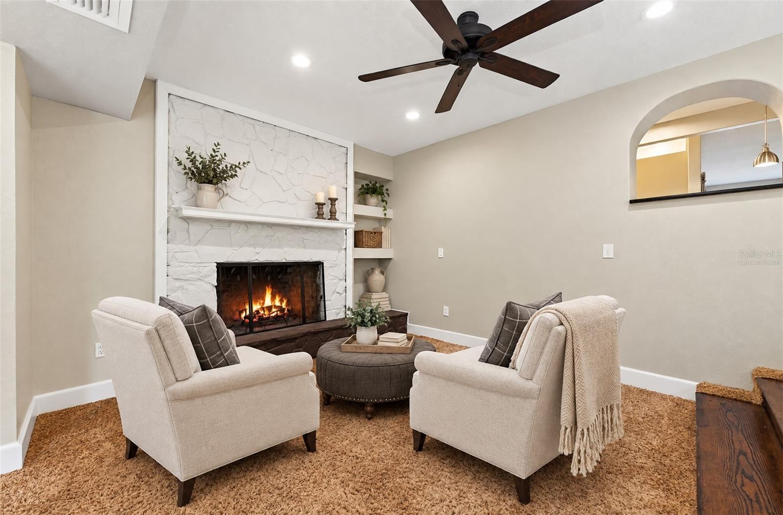The first area of the family room features a fireplace feature wall. Virtually Staged.