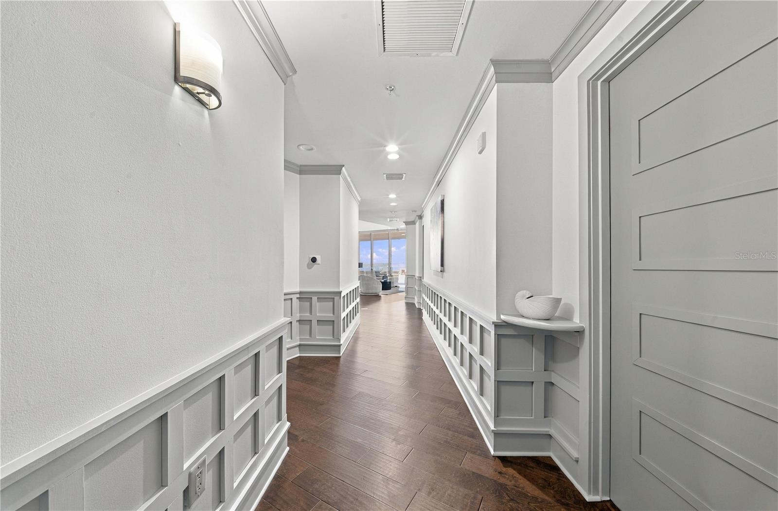 Long Foyer Entry | A defined arrival leads directly toward the light and skyline beyond