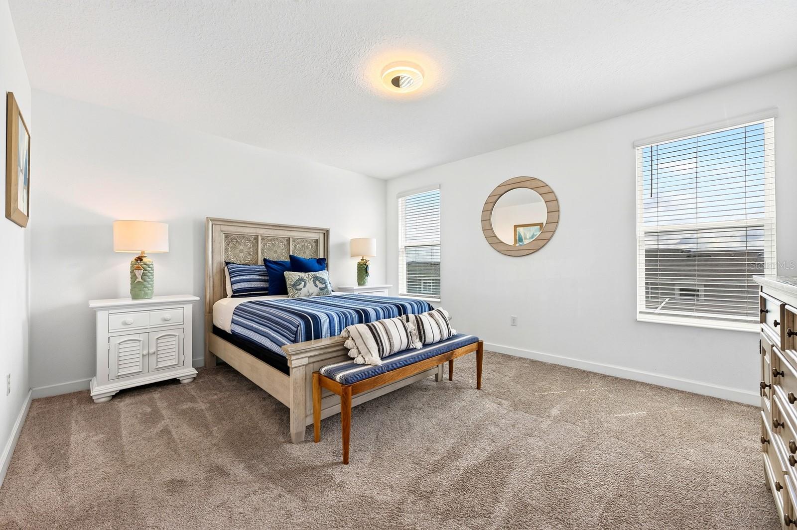 The generous PRIMARY SUITE is filled with NATURAL LIGHT and offers a WALK-IN CLOSET and private en-suite bath.