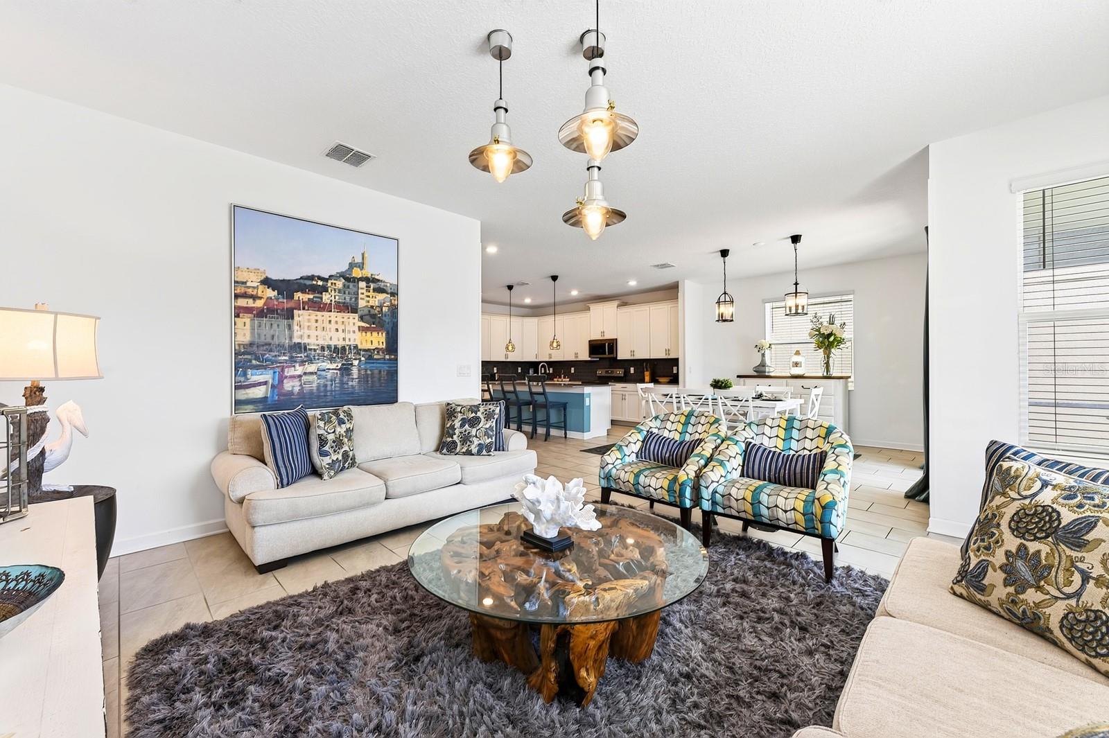 The expansive Living Room invites connection and comfort.