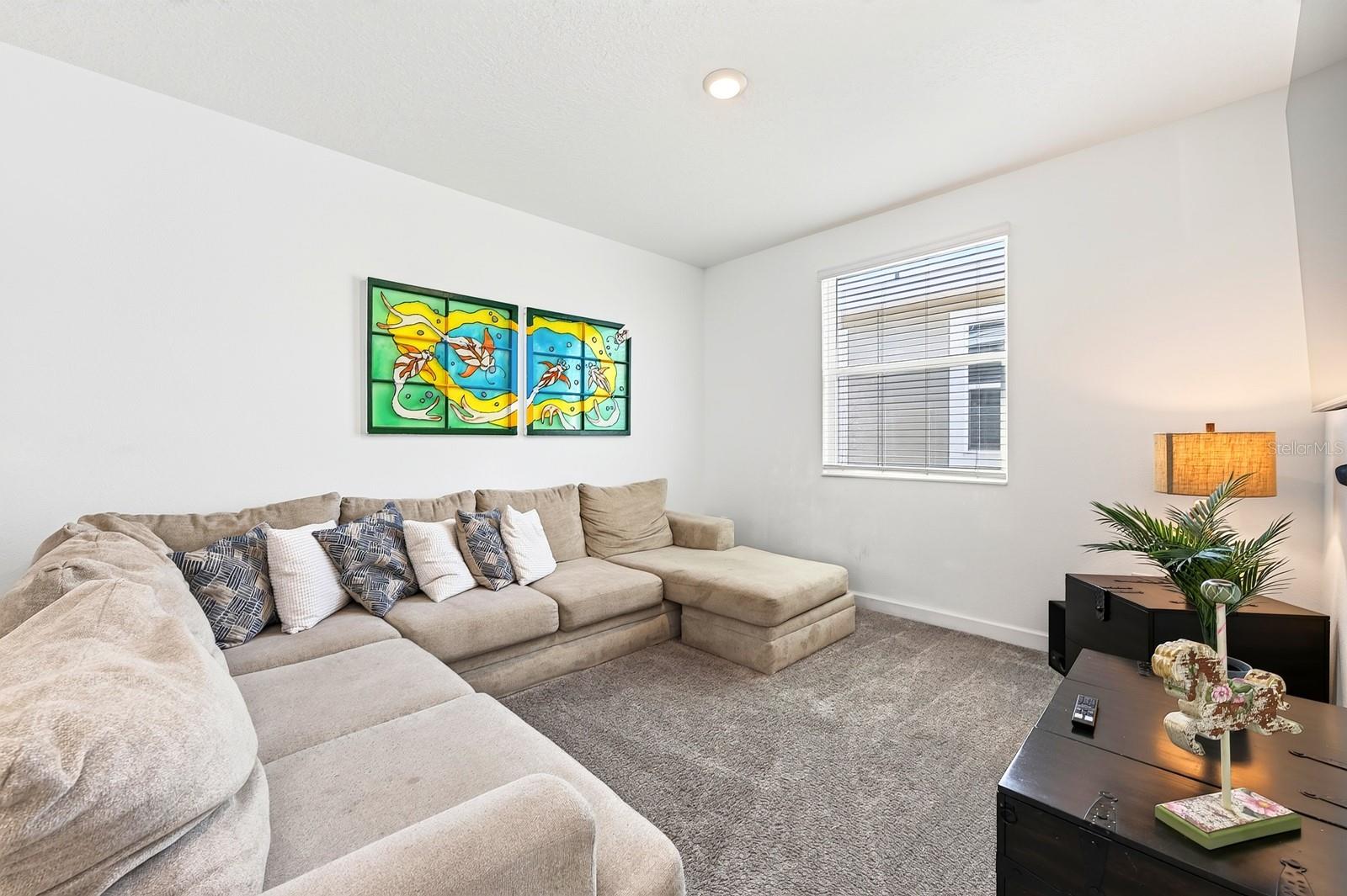 A SPACIOUS LOFT at the top of the stairs provides an additional gathering area, game space or flexible retreat.