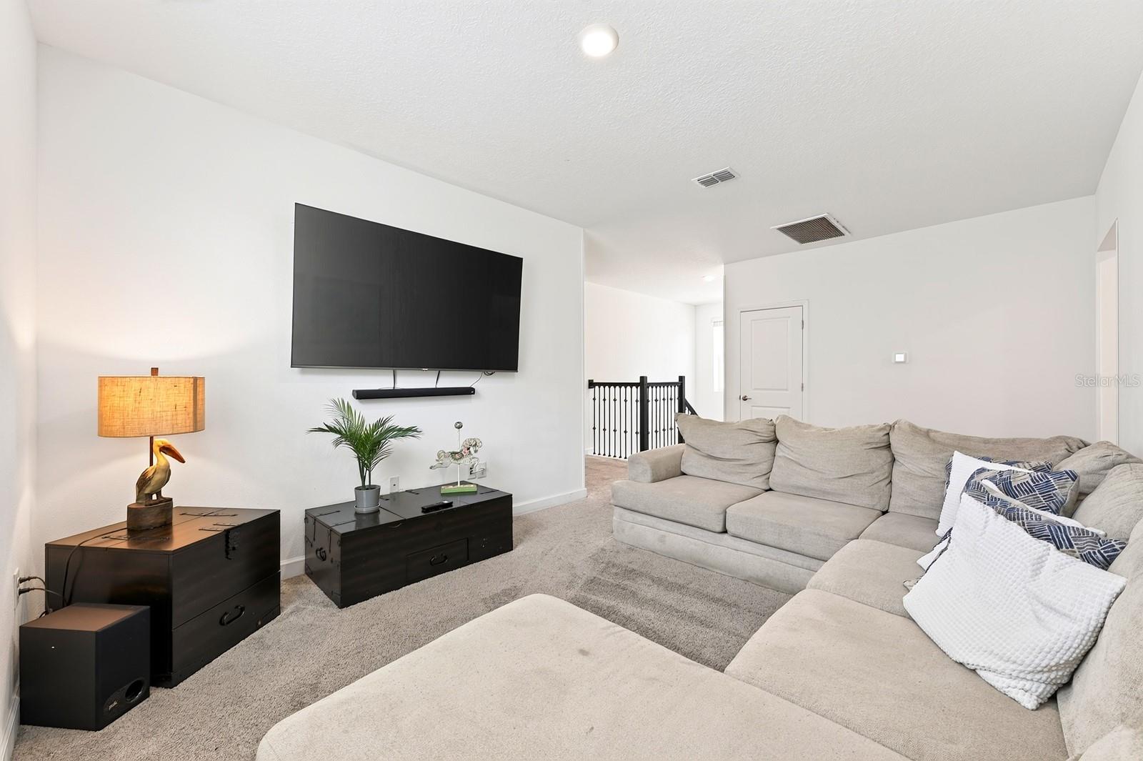 A SPACIOUS LOFT at the top of the stairs provides an additional gathering area, game space or flexible retreat.