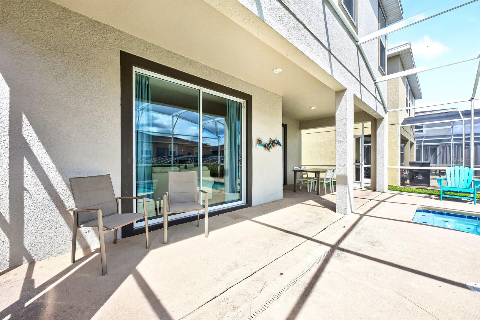 Sliding glass doors lead to your COVERED PATIO and PRIVATE POOL, all enclosed within a SCREENED LANAI.