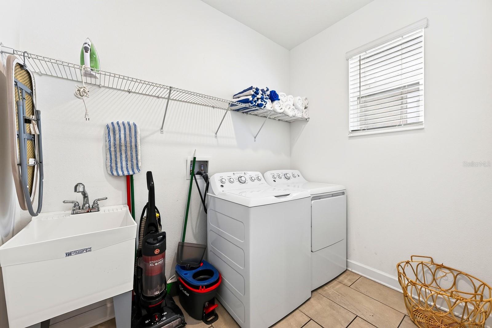 A convenient Laundry Room with UTILITY TUB and INCLUDED WASHER AND DRYER completes the first floor.