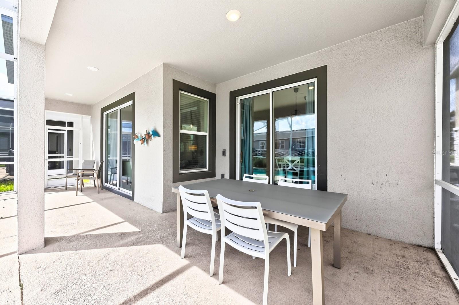 Sliding glass doors lead to your COVERED PATIO and PRIVATE POOL, all enclosed within a SCREENED LANAI.