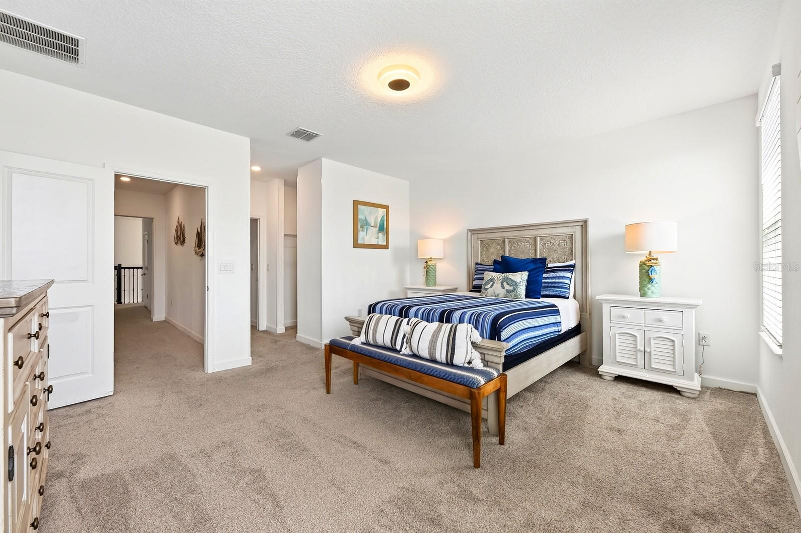 The generous PRIMARY SUITE is filled with NATURAL LIGHT and offers a WALK-IN CLOSET and private en-suite bath.