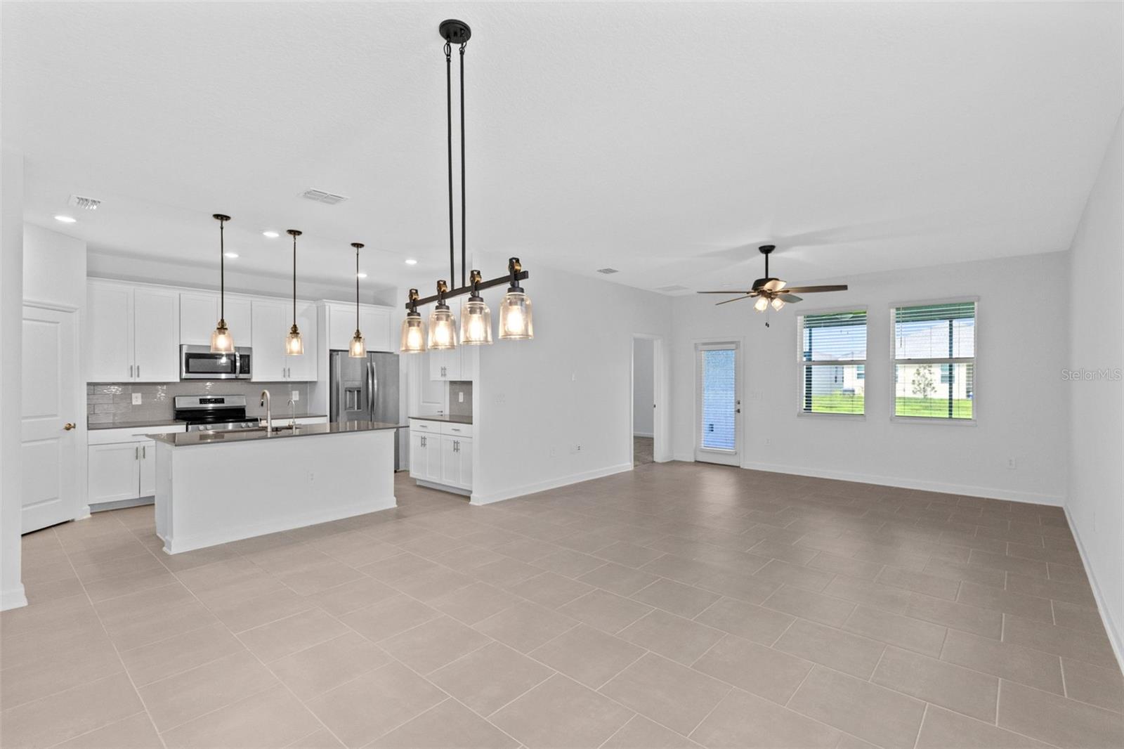 The open kitchen, dining and living spaces flow together beautifully, creating plenty of room for both everyday living and entertaining.