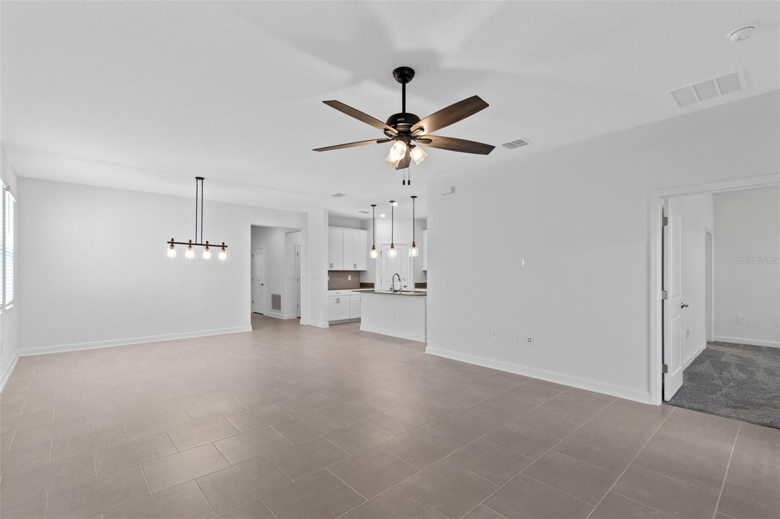 The open kitchen, dining and living spaces flow together beautifully, creating plenty of room for both everyday living and entertaining.