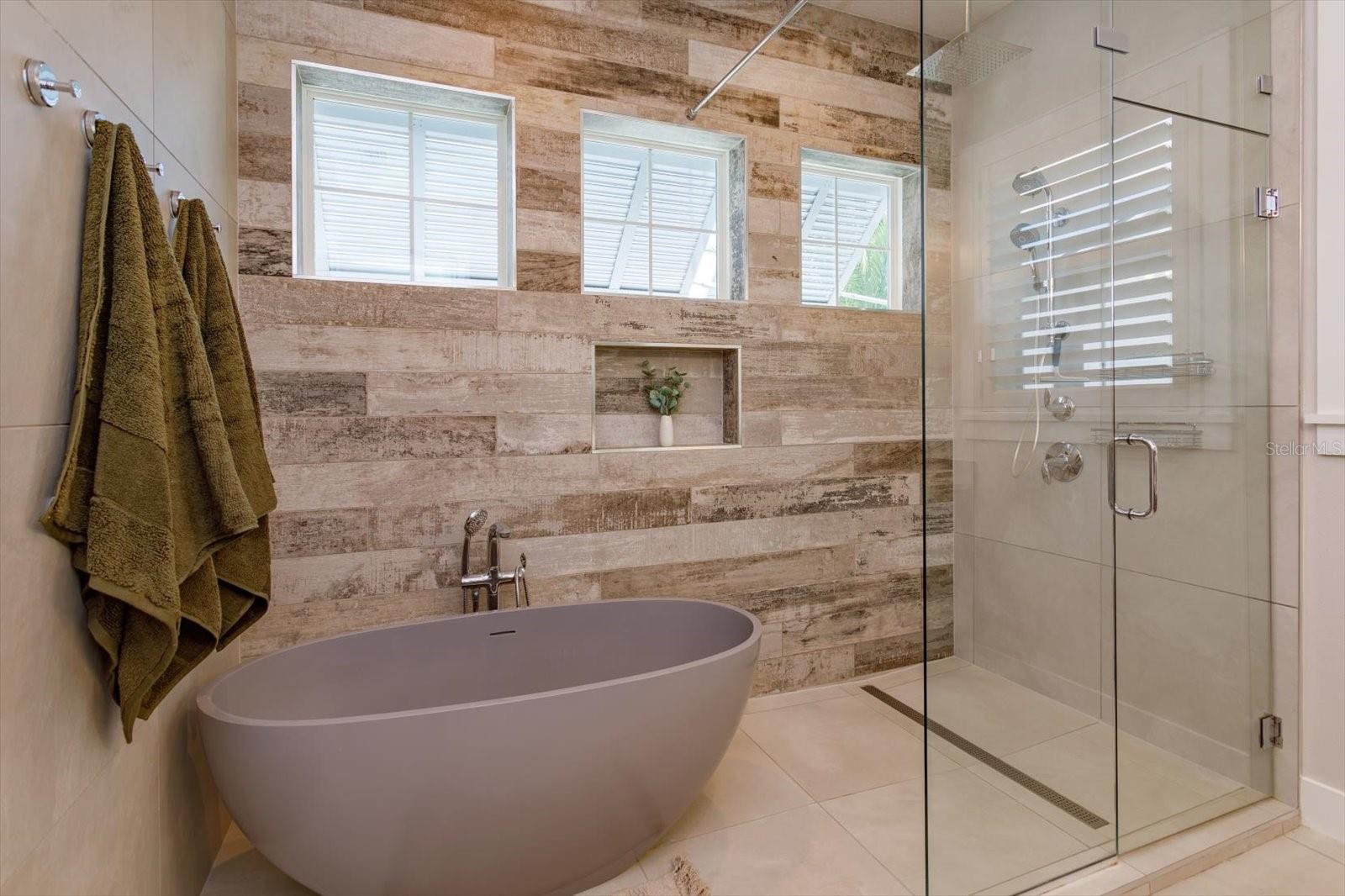 Primary bath with soaking tub and seamless glass shower