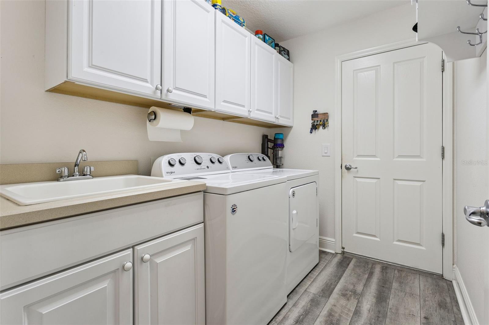 Indoor laundry room with utility sink