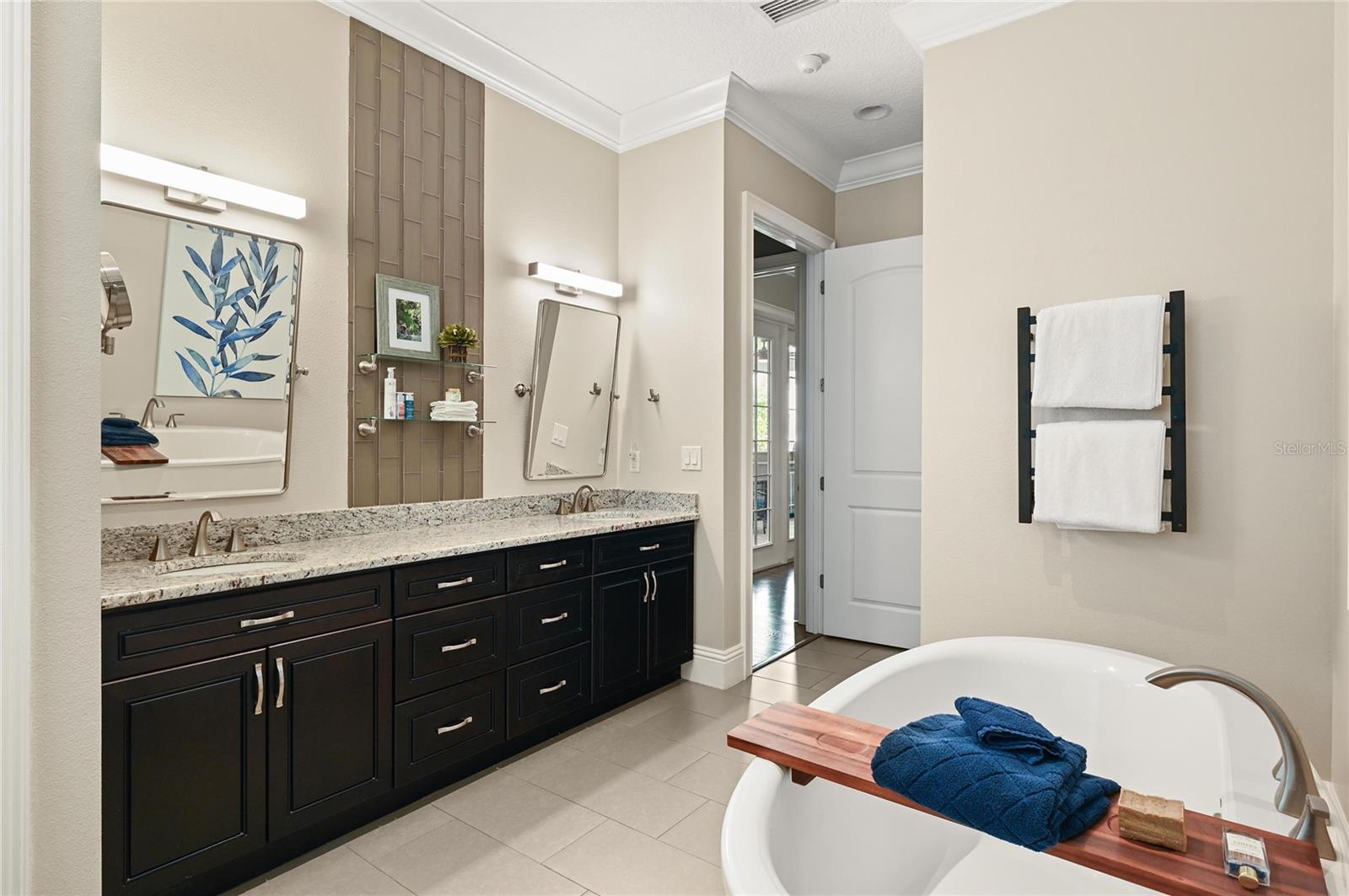 The master suite features 8-foot doors, a large linen closet, double sinks as well as dual shower heads and a hard-wired towel warming rack.