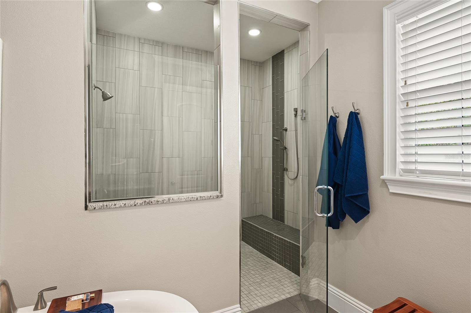 The oversized shower was thoughtfully designed with a handy bench seat and controls located just inside the shower opening.