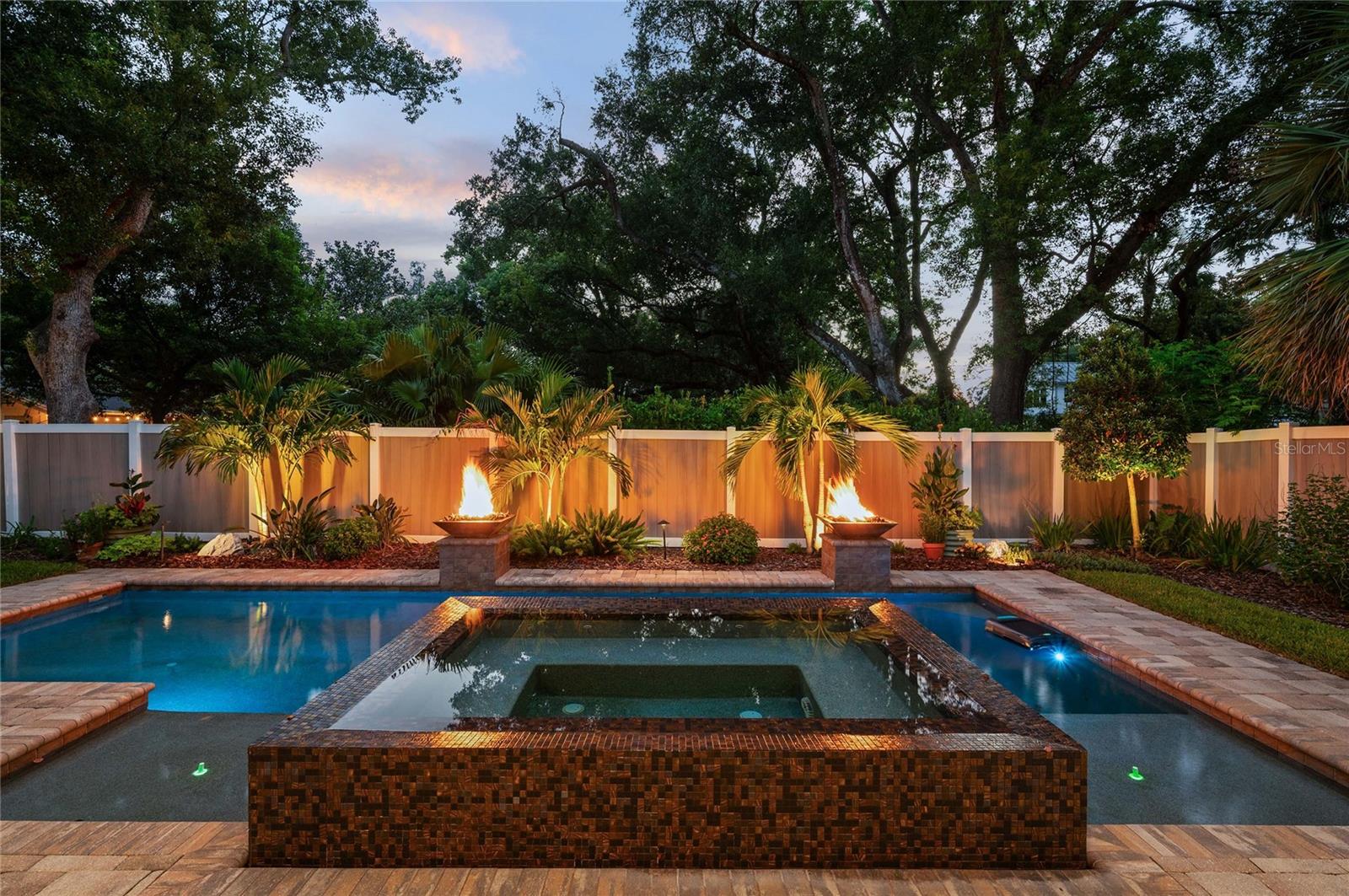 Twilight is magical overlooking the spill-over spa with gas firepits.
