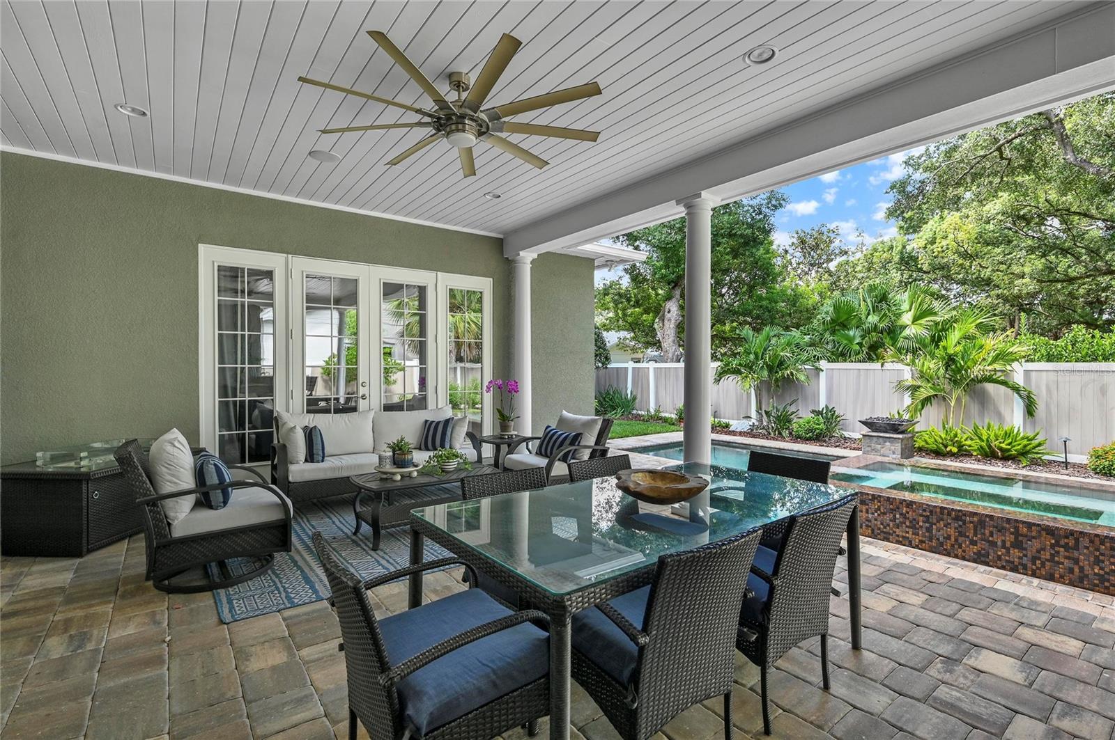 Meals at the outdoor table come with a show-stopping view to the private backyard oasis.