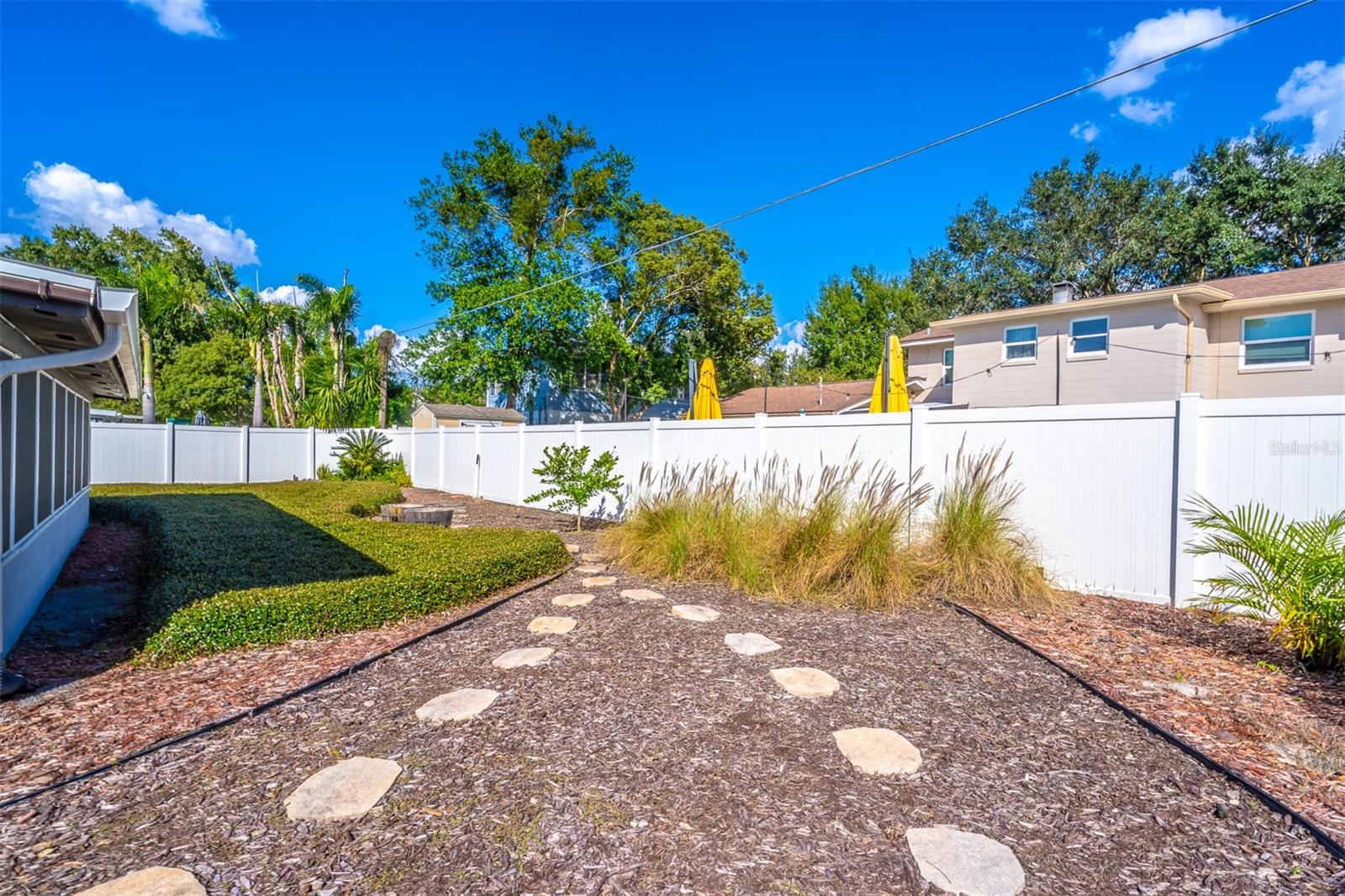 Landscaped Backyard with Vinyl Fence