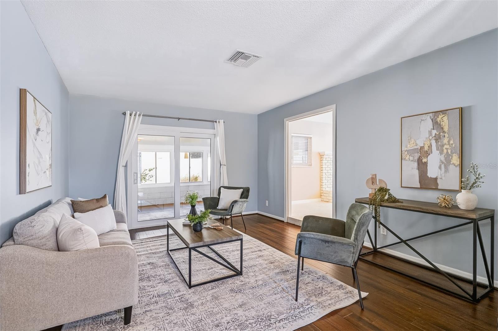 Family Room with Sliders Leading to Enclosed Lanai
