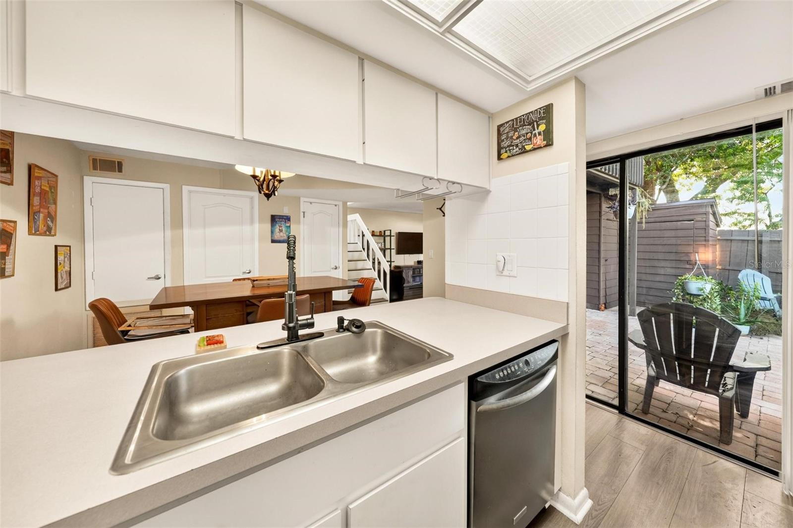 Kitchen with courtyard access through sliding glass doors.