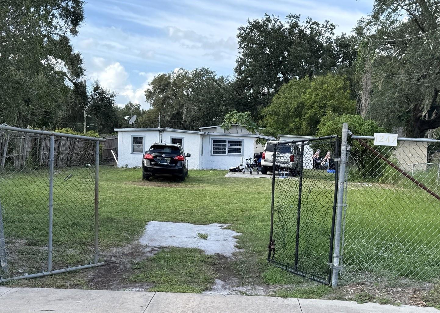 1247 19th Street wide exterior view, the third contiguous preproperty - showing the fenced lot and setback from the street 1247 19th Street wide exterior view, the third contiguous preproperty - showing the fenced lot and setback from the street