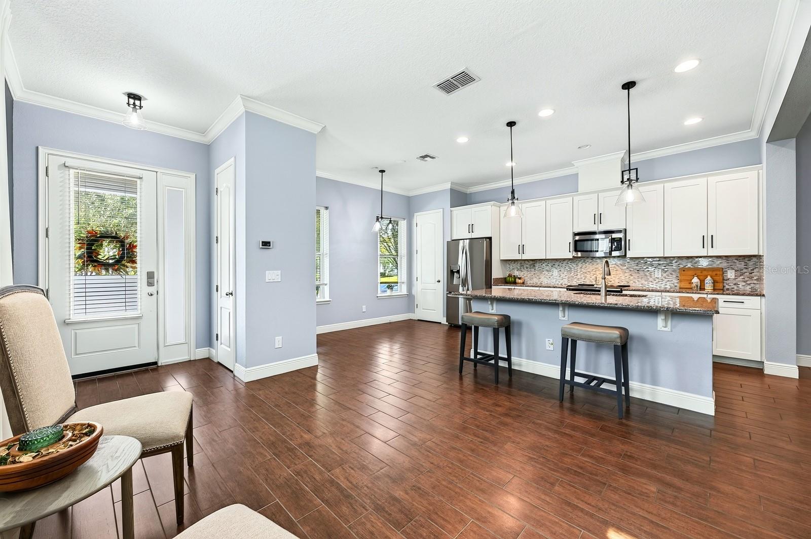 Kitchen is open to flexible dining spaces.