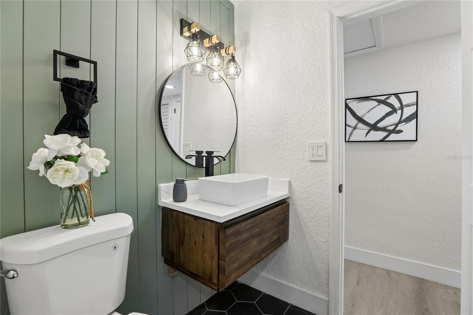Beautifully redesigned second full bathroom with warm wood accents