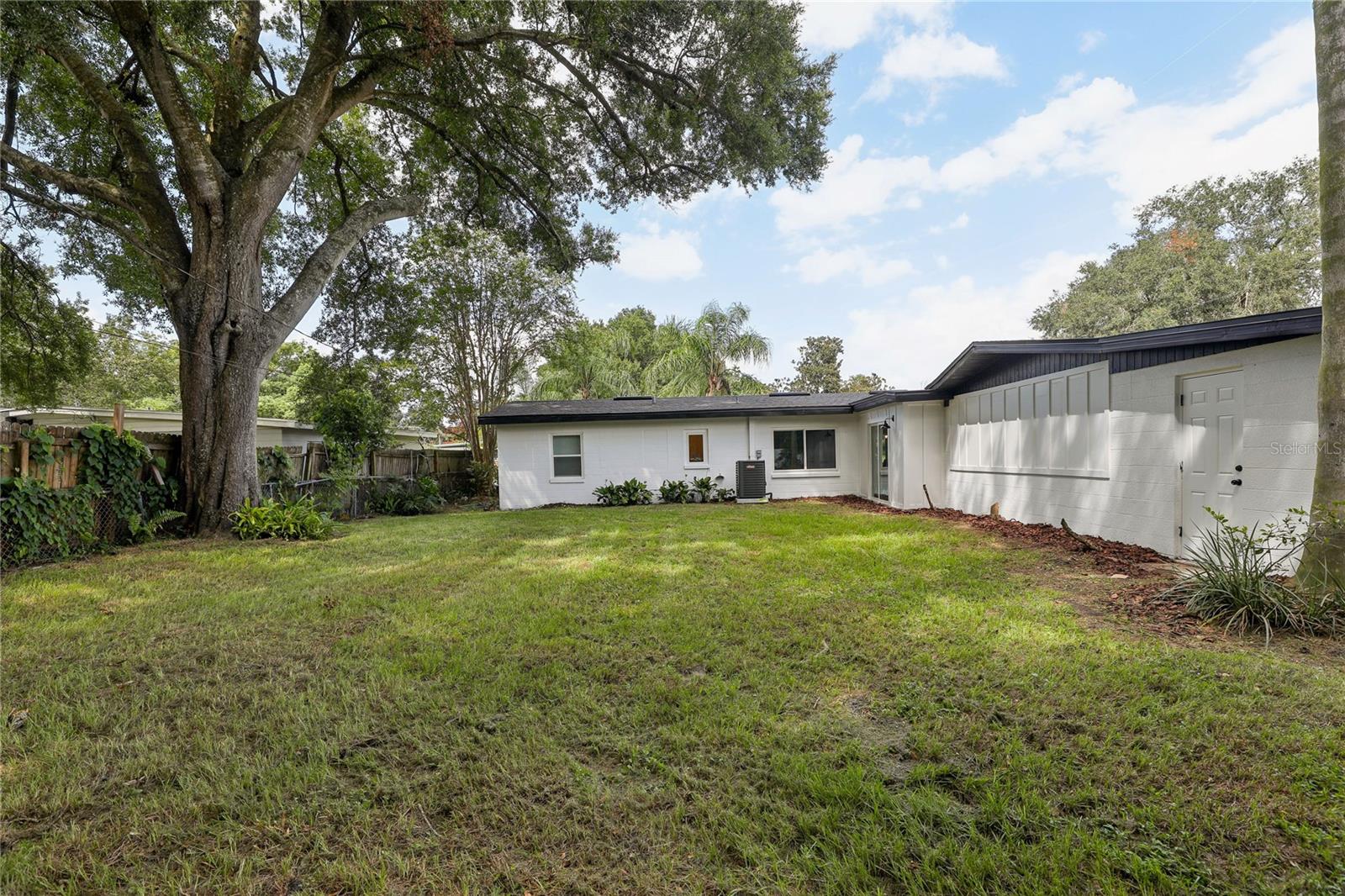HUGE backyard with mature trees and plenty of room to enjoy the Florida lifestyle