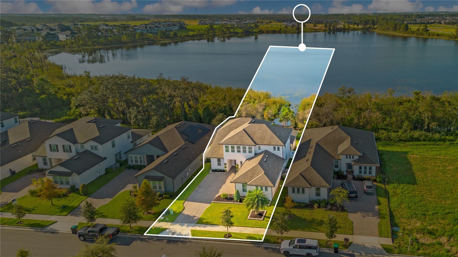 Aerial view highlights the homes setting beside the lake. Outline is approximate and for illustration only.
