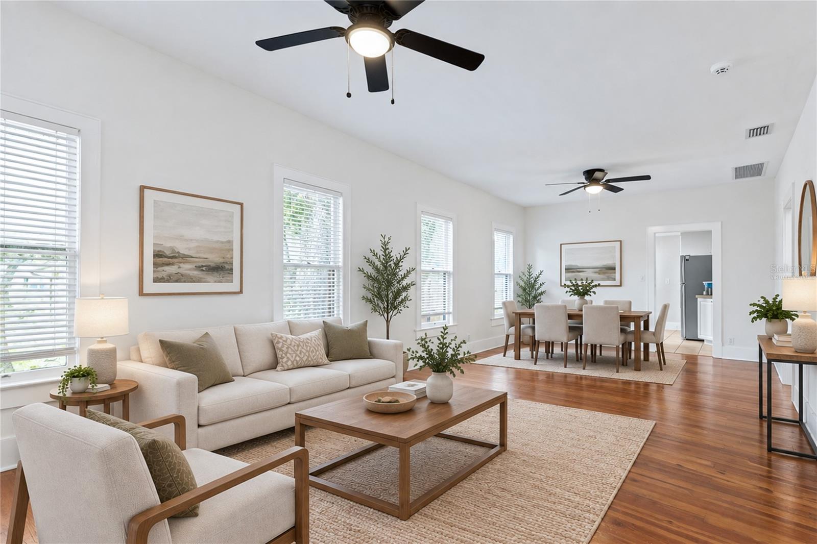 Virtually staged image. Living Room and Dining.