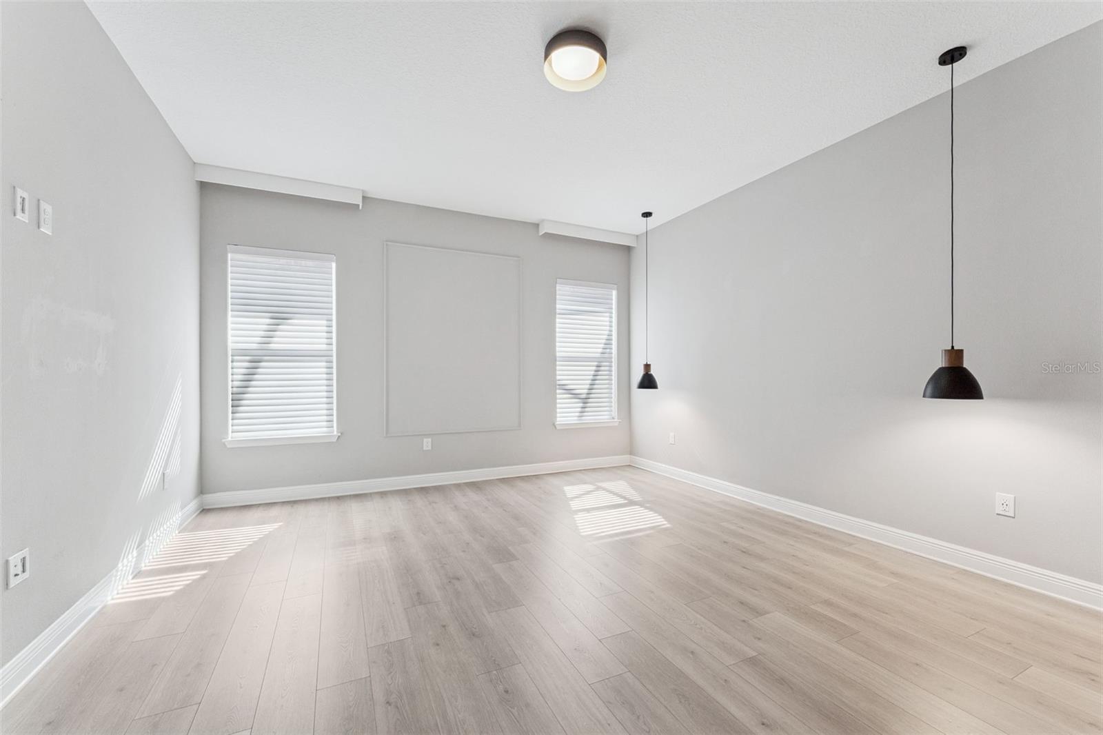 Bright primary bedroom with ample space and natural light.